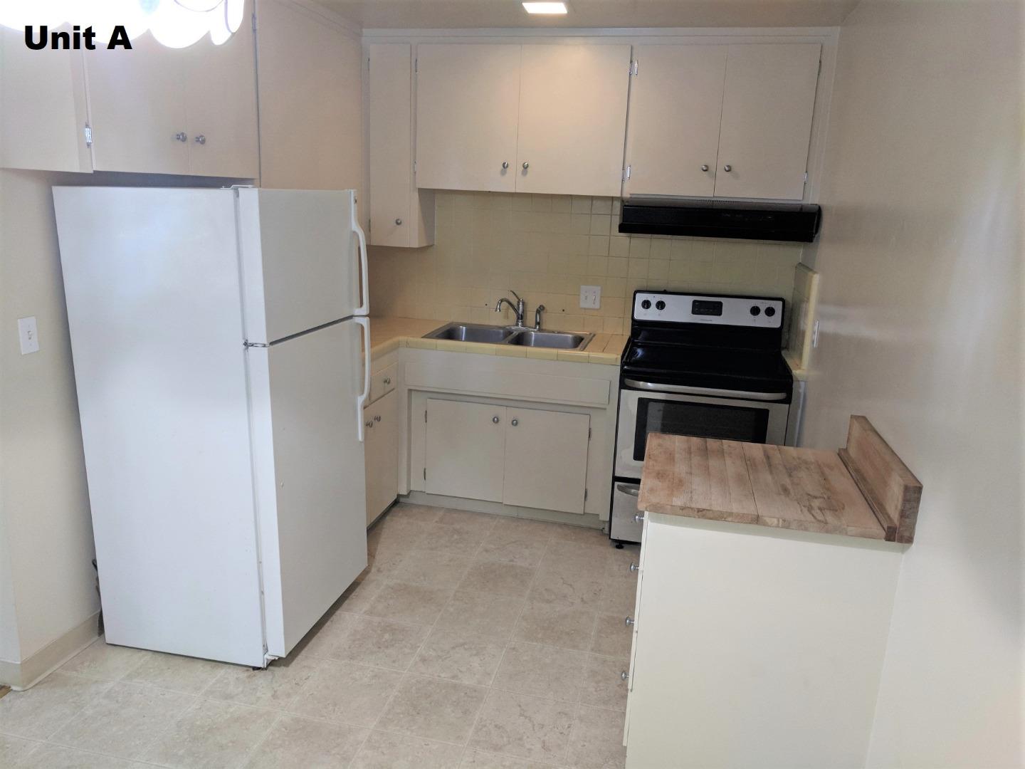 1830 48th Avenue Capitola, CA 95010 - Photo 20 of 32 a kitchen with a refrigerator sink and cabinets