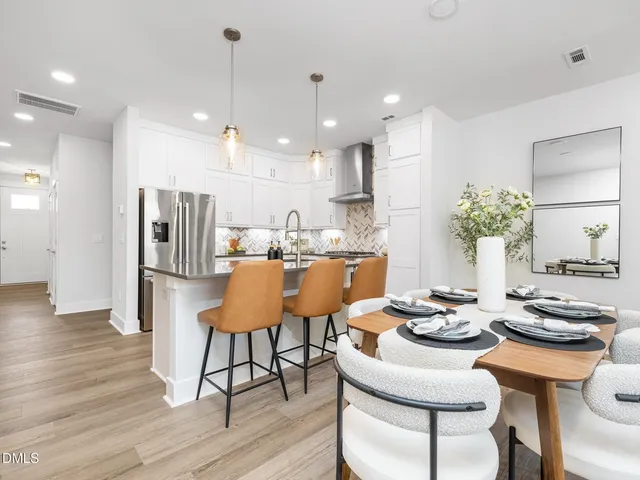 a kitchen with a table and chairs in it