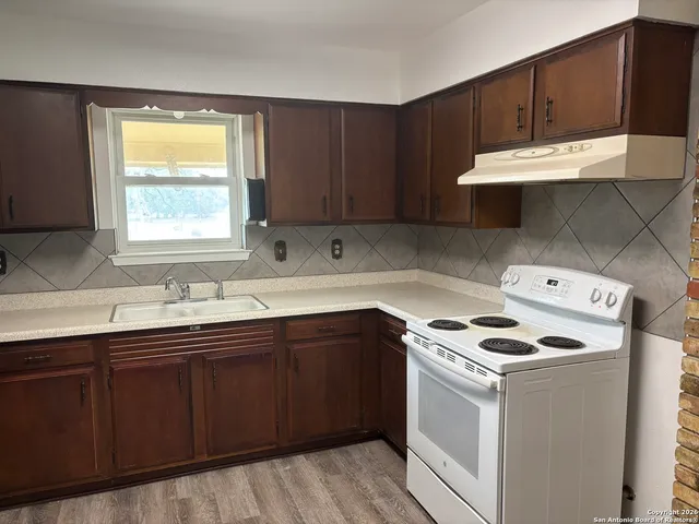 a kitchen with a sink and a stove