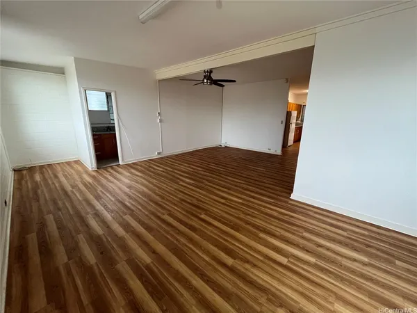 a view of a big room with wooden floor and closet