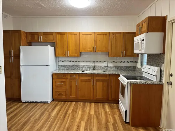 a kitchen with a refrigerator sink stove and cabinets