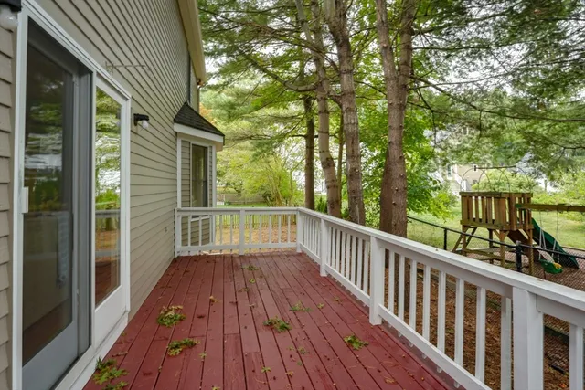 a view of balcony with wooden floor and fence