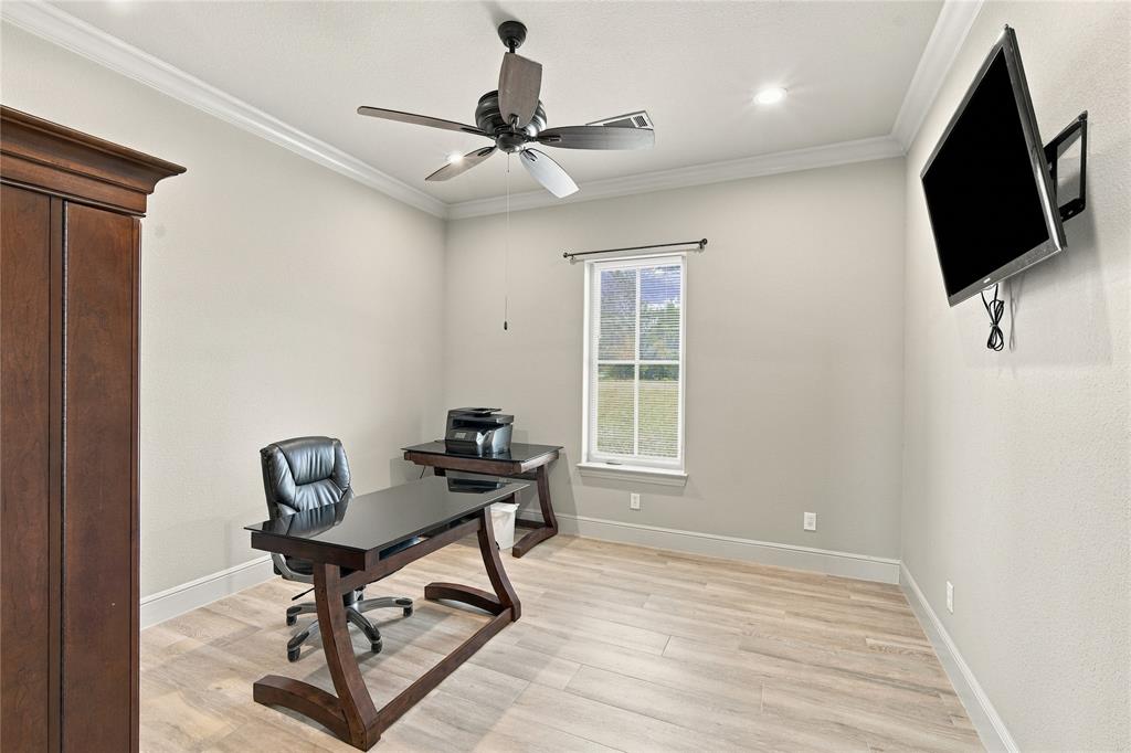 1180 Wiggins Road Maypearl, TX 76064 - Photo 20 of 40 A quiet home office with crown molding and great natural light, ready for remote work or a private study.