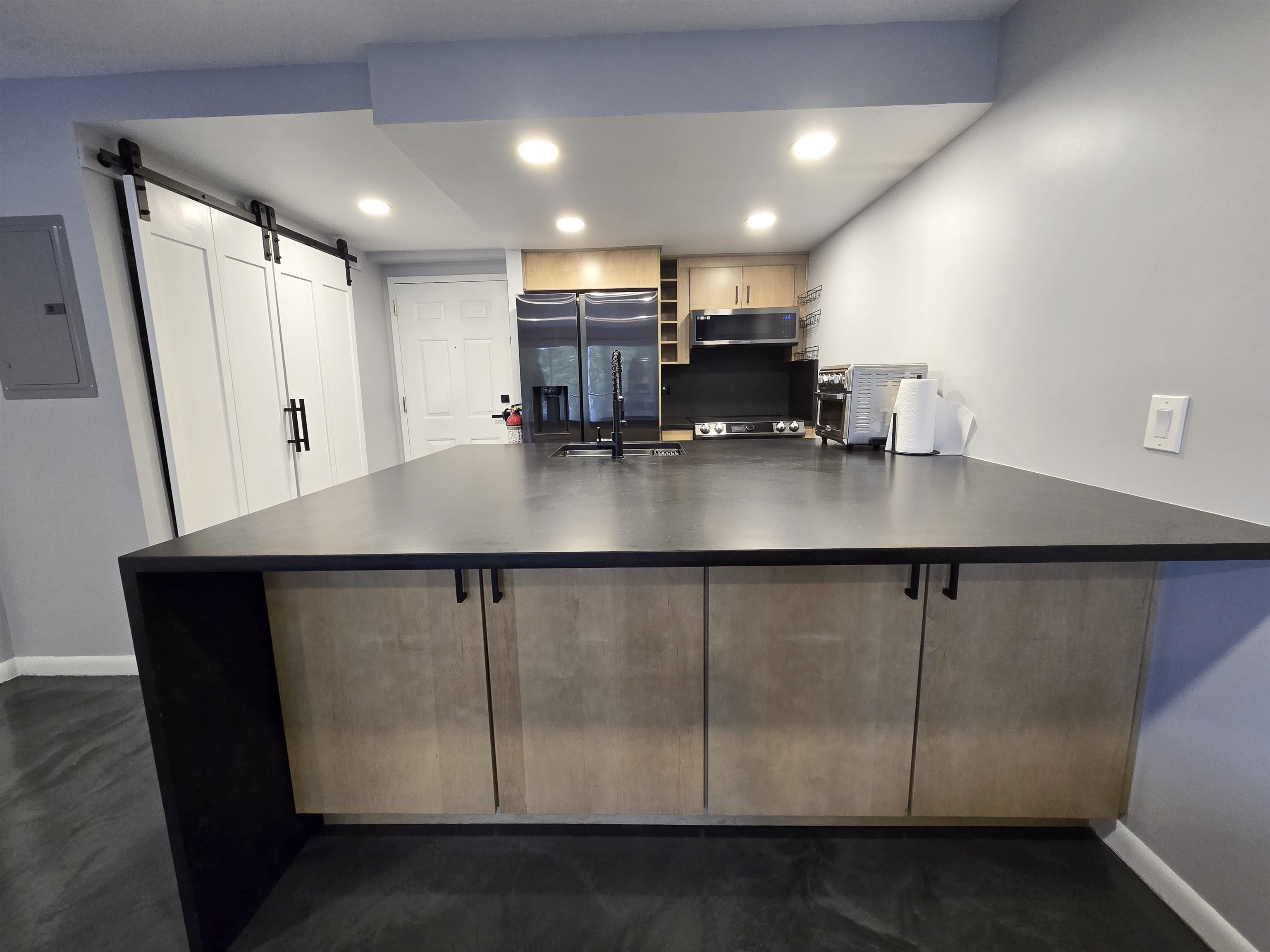 55 Clinton Place, Unit 308 Hackensack, NJ 07601 - Photo 14 of 19 a kitchen with stainless steel appliances a table chairs and wooden floor