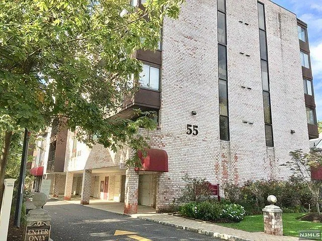 front view of a brick house with a yard