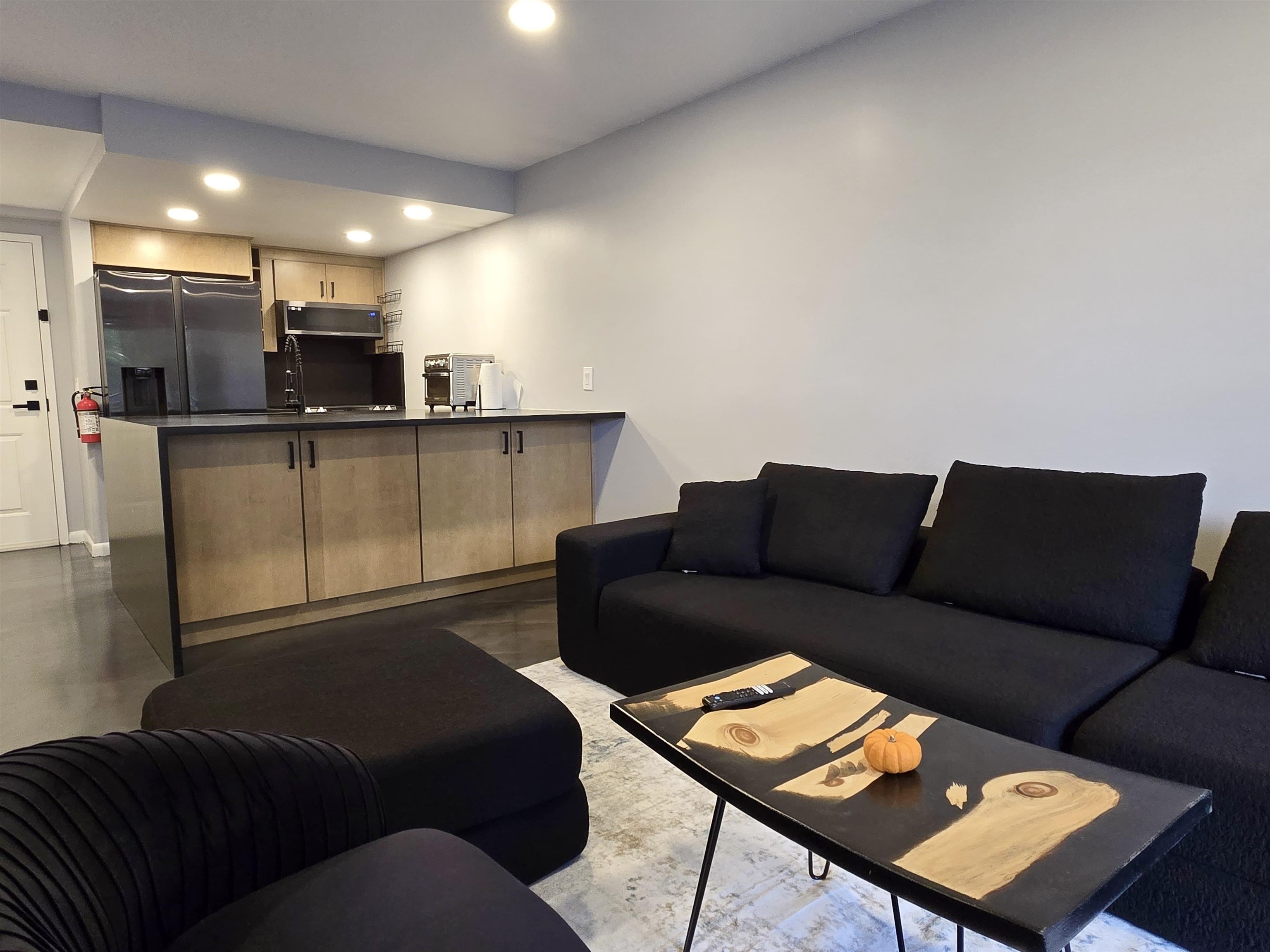 55 Clinton Place, Unit 308 Hackensack, NJ 07601 - Photo 2 of 19 a living room with furniture and a flat screen tv