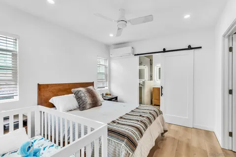 a bedroom with a bed and wooden floor