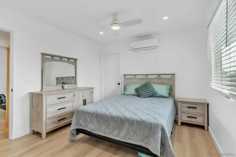 a bedroom with a bed and a dresser