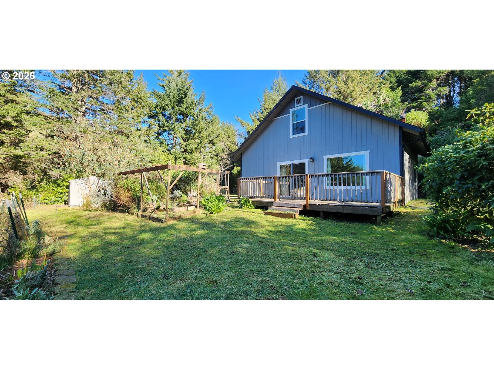 94516 Riley Creek Way Gold Beach, OR 97444 - Photo 28 of 35 a view of a backyard with table and chairs and potted plants