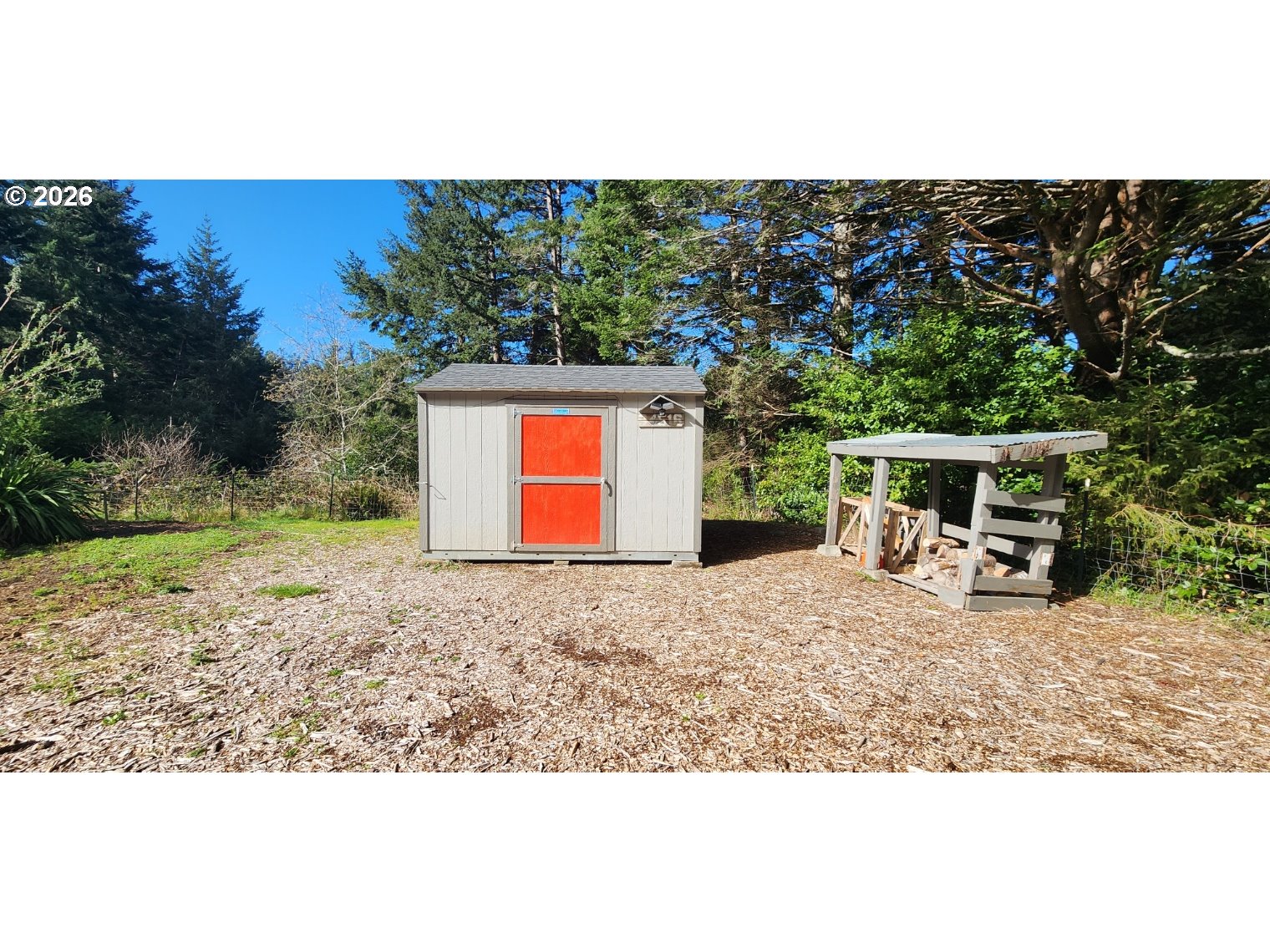 94516 Riley Creek Way Gold Beach, OR 97444 - Photo 34 of 35 a view of a house with backyard porch and sitting area