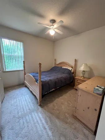 a spacious bedroom with a bed and a window