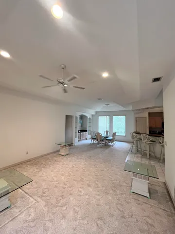 a view of a livingroom with furniture and a flat screen tv