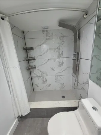 a bathroom with a toilet and shower