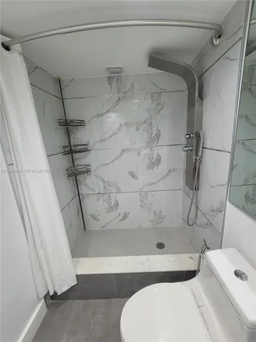 a bathroom with a toilet and shower
