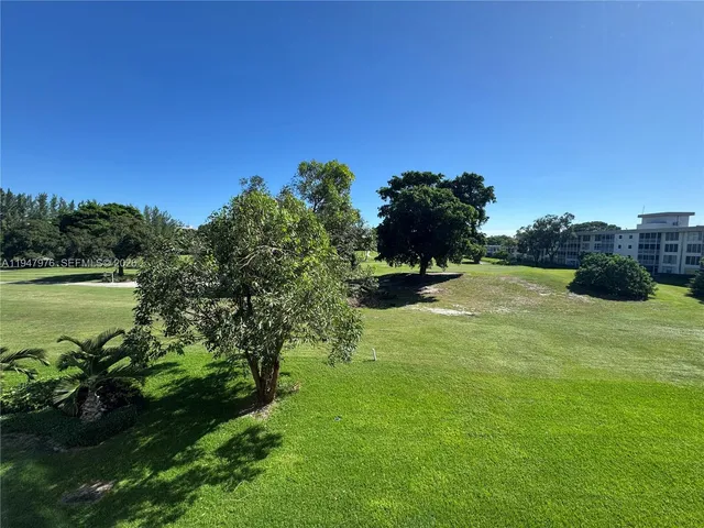 a view of a garden with a building in the background