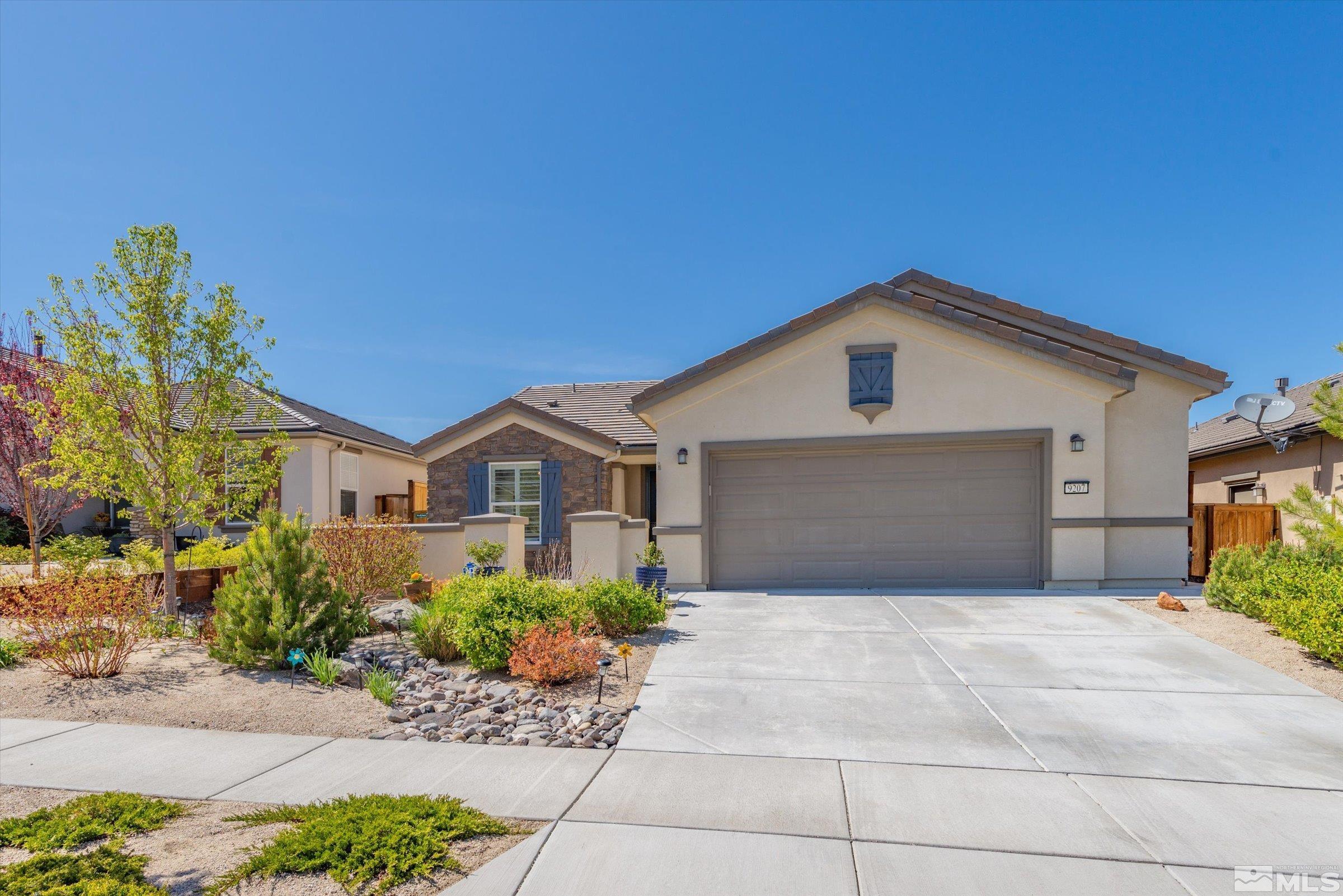 9207 Maplehurst Trail Reno, NV 89523 - Photo 1 of 40 a front view of a house with a yard and garage