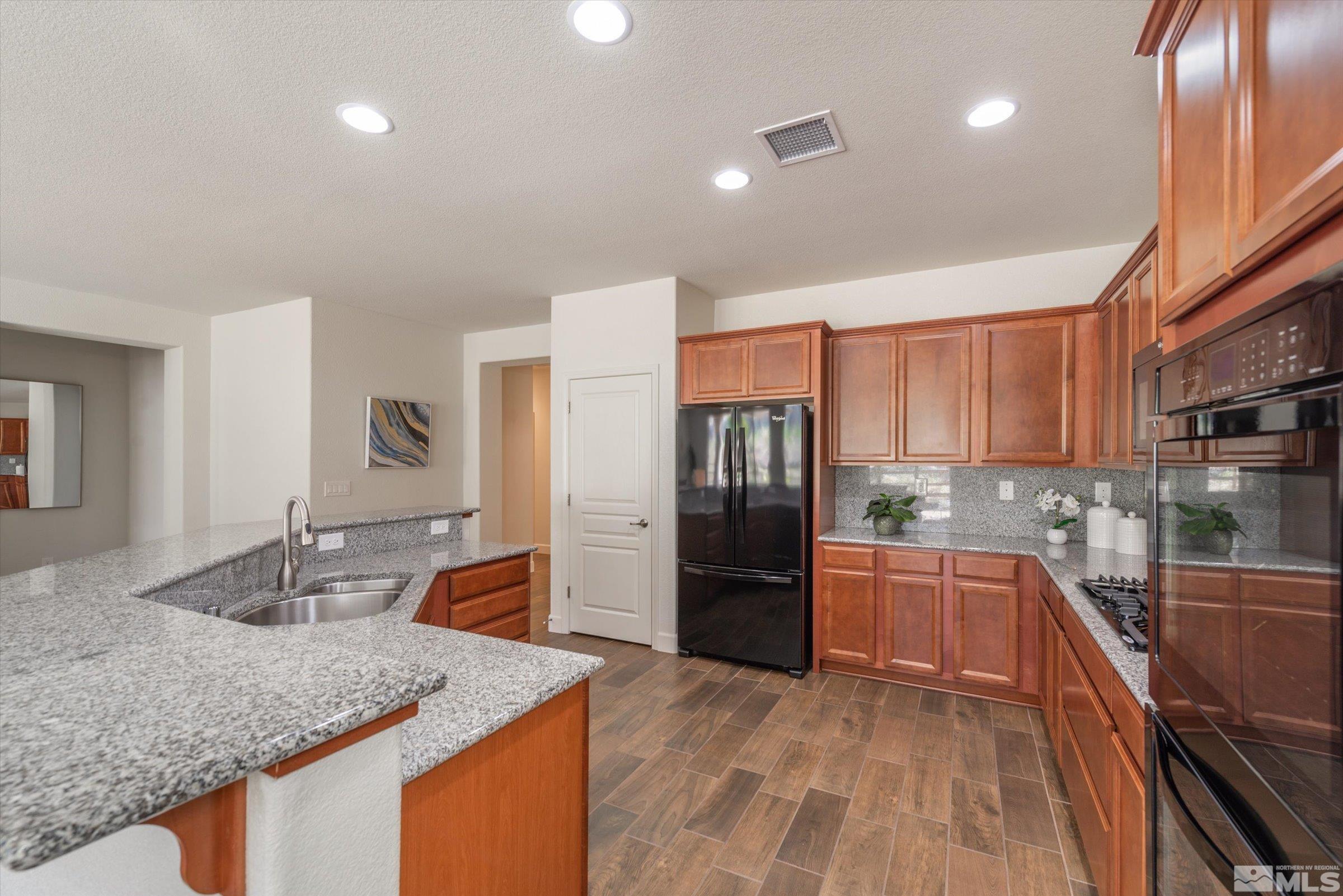 9207 Maplehurst Trail Reno, NV 89523 - Photo 14 of 40 a kitchen with stainless steel appliances granite countertop a sink and cabinets