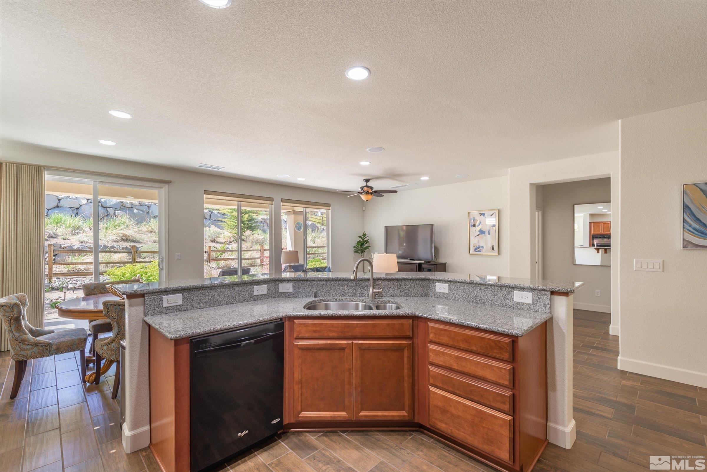 9207 Maplehurst Trail Reno, NV 89523 - Photo 16 of 40 a kitchen with granite countertop stainless steel appliances a sink and cabinets