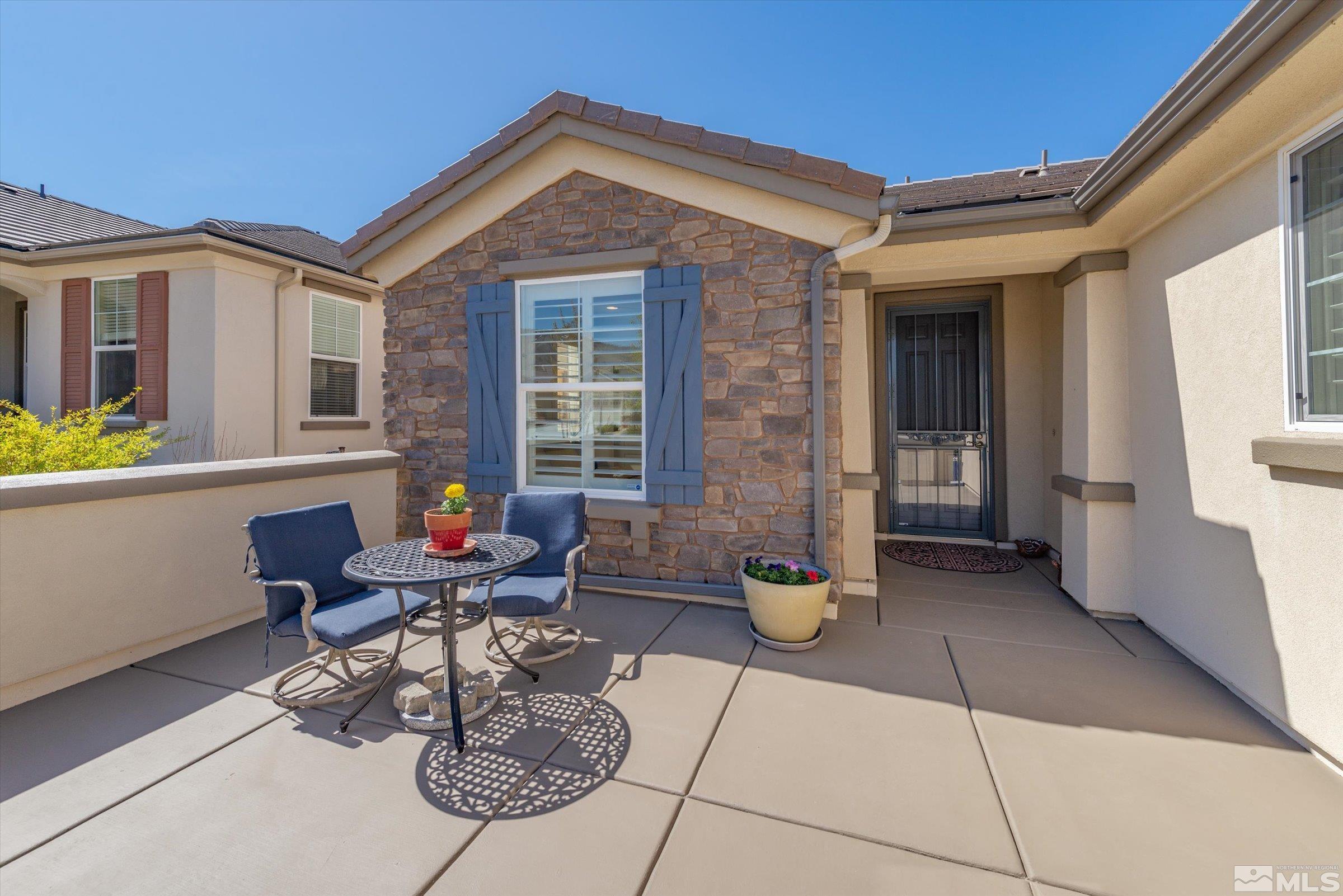 9207 Maplehurst Trail Reno, NV 89523 - Photo 2 of 40 a building outdoor space with patio furniture and potted plants