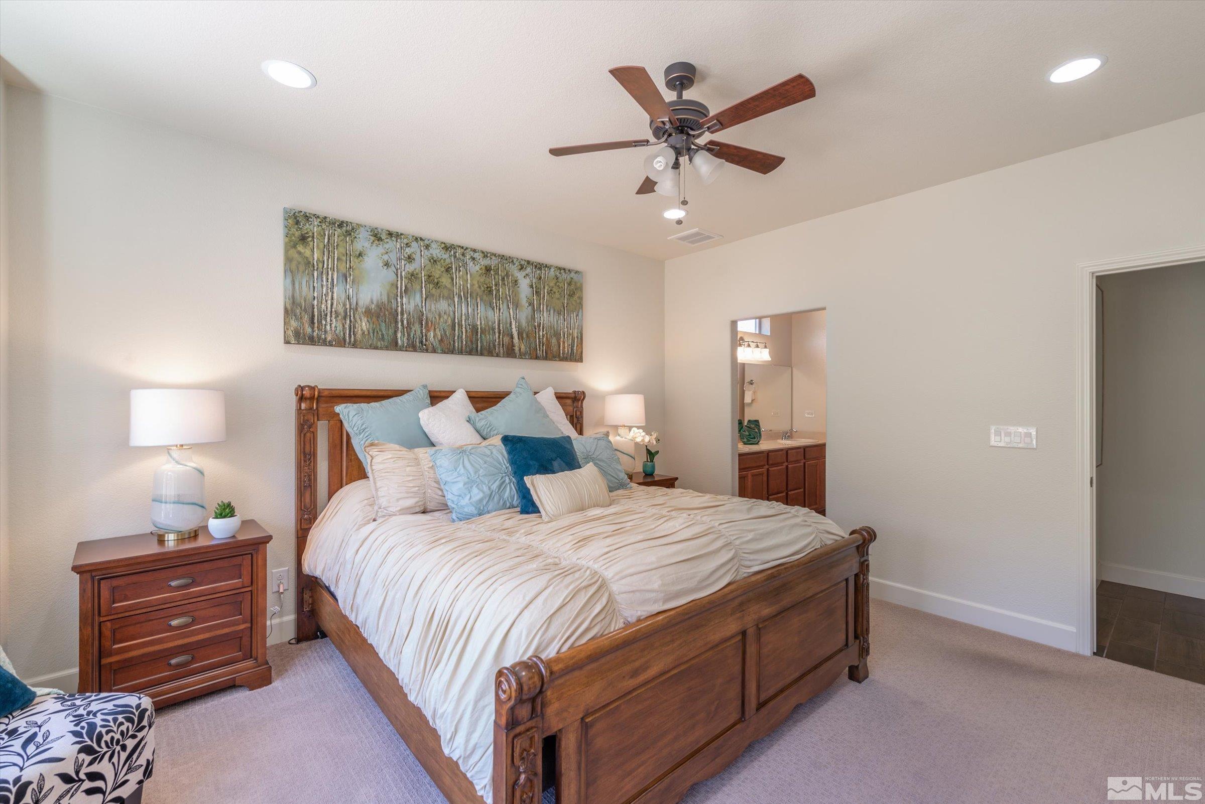 9207 Maplehurst Trail Reno, NV 89523 - Photo 23 of 40 a bedroom with a large bed and a chandelier