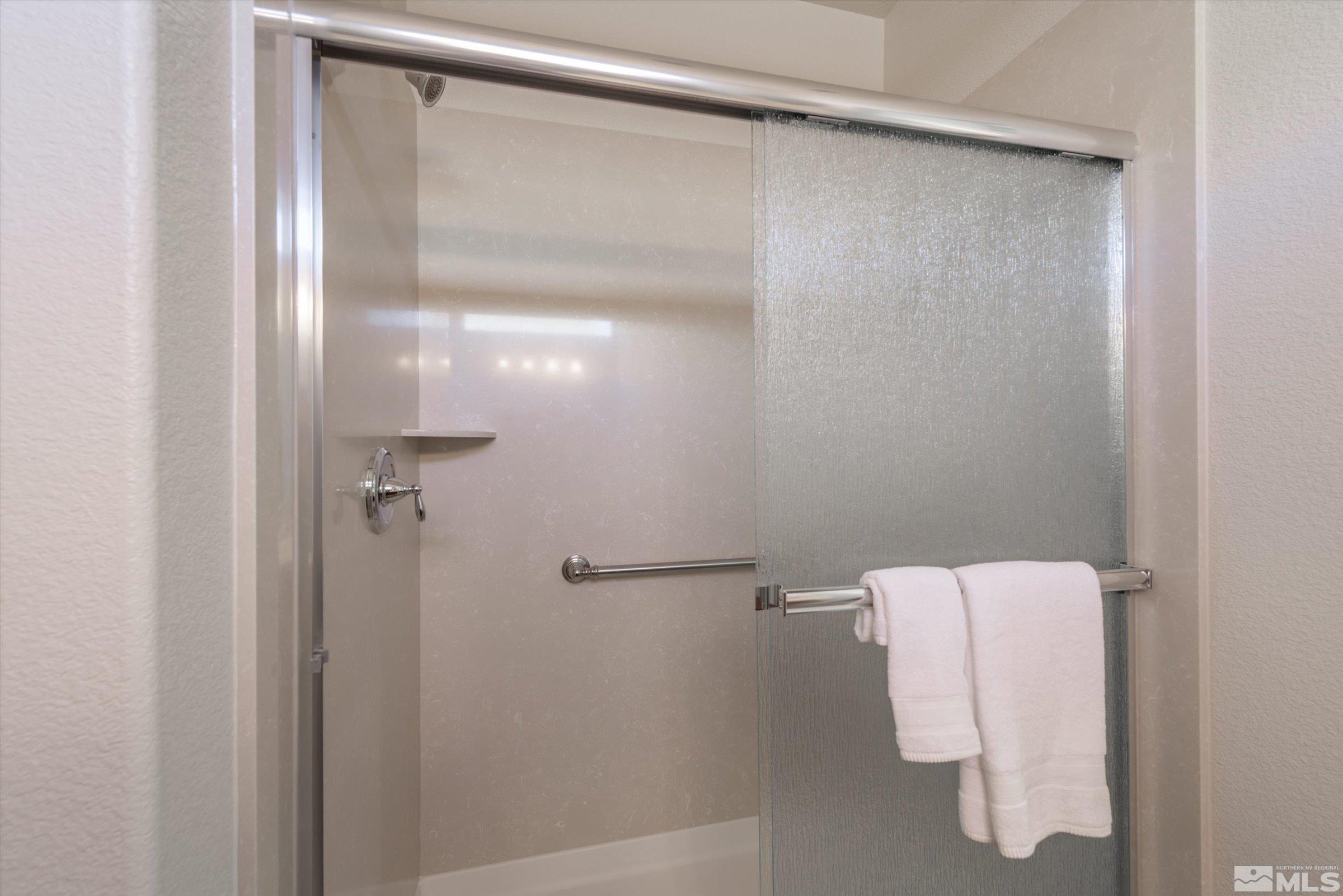 9207 Maplehurst Trail Reno, NV 89523 - Photo 25 of 40 a bathroom with a glass shower door
