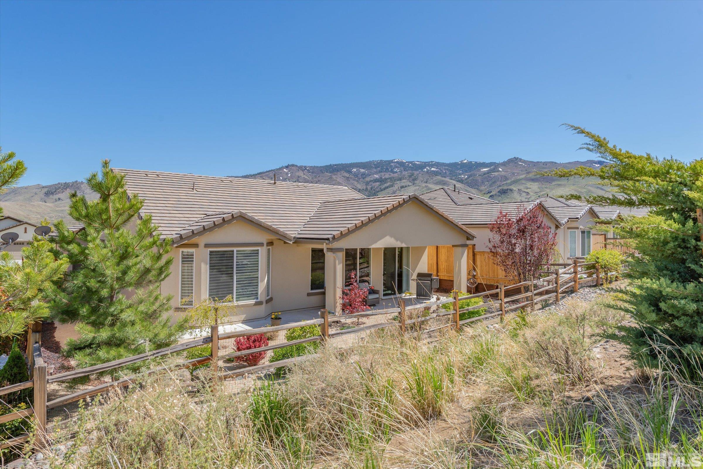 9207 Maplehurst Trail Reno, NV 89523 - Photo 5 of 40 a view of a house with a big yard and large tree