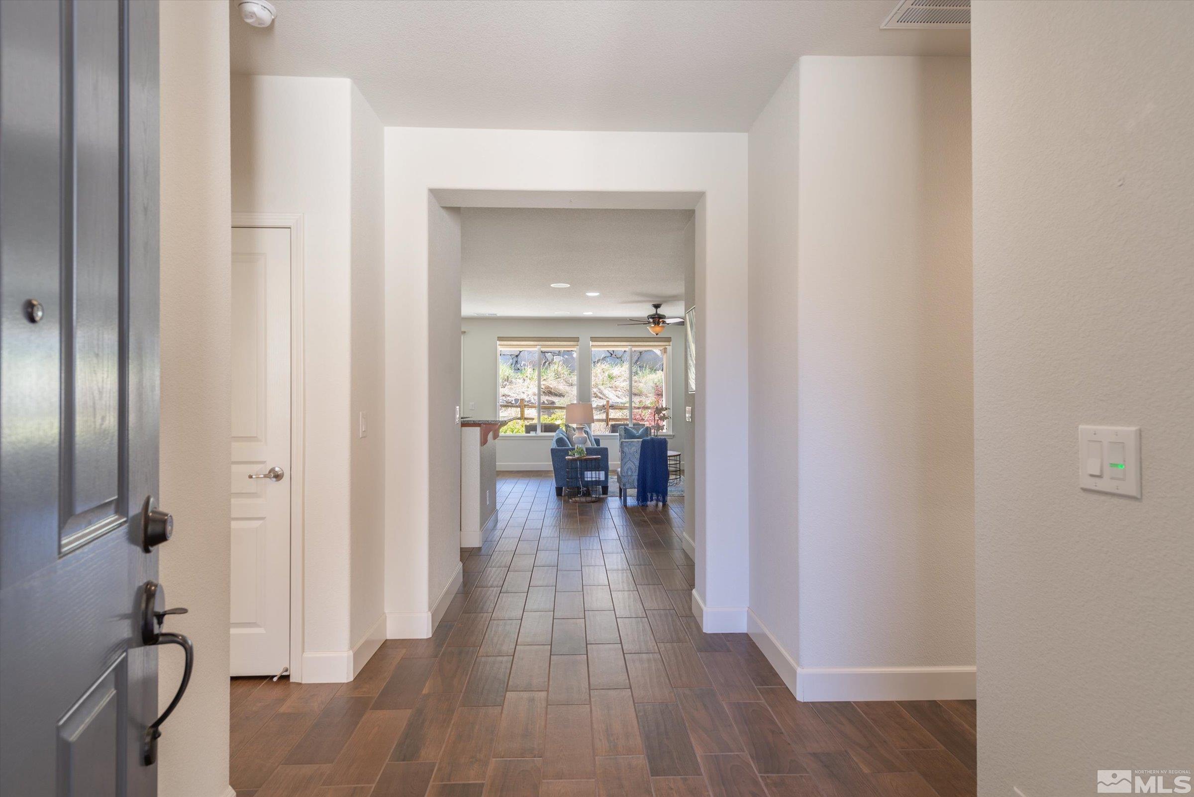 9207 Maplehurst Trail Reno, NV 89523 - Photo 8 of 40 a hallway with wooden floor fireplace and living room