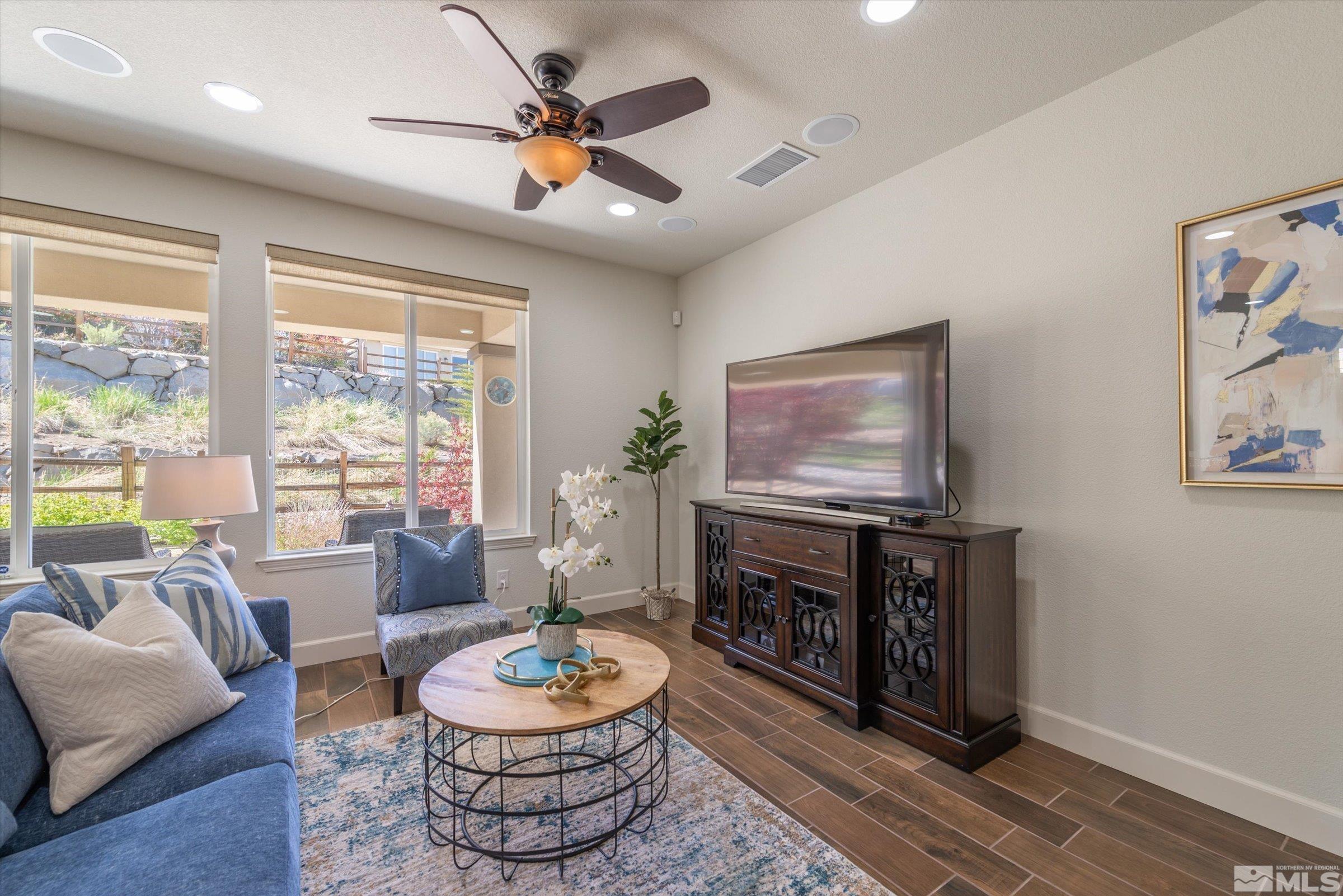 9207 Maplehurst Trail Reno, NV 89523 - Photo 10 of 40 a living room with furniture a flat screen tv and a large window
