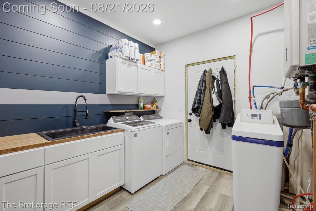 9161 East Coldwater Road Davison, MI 48423 - Photo 37 of 52 Laundry space featuring shiplap wall accents, white cabinetry, a wood-finish countertop, and a black sink with a gooseneck faucet