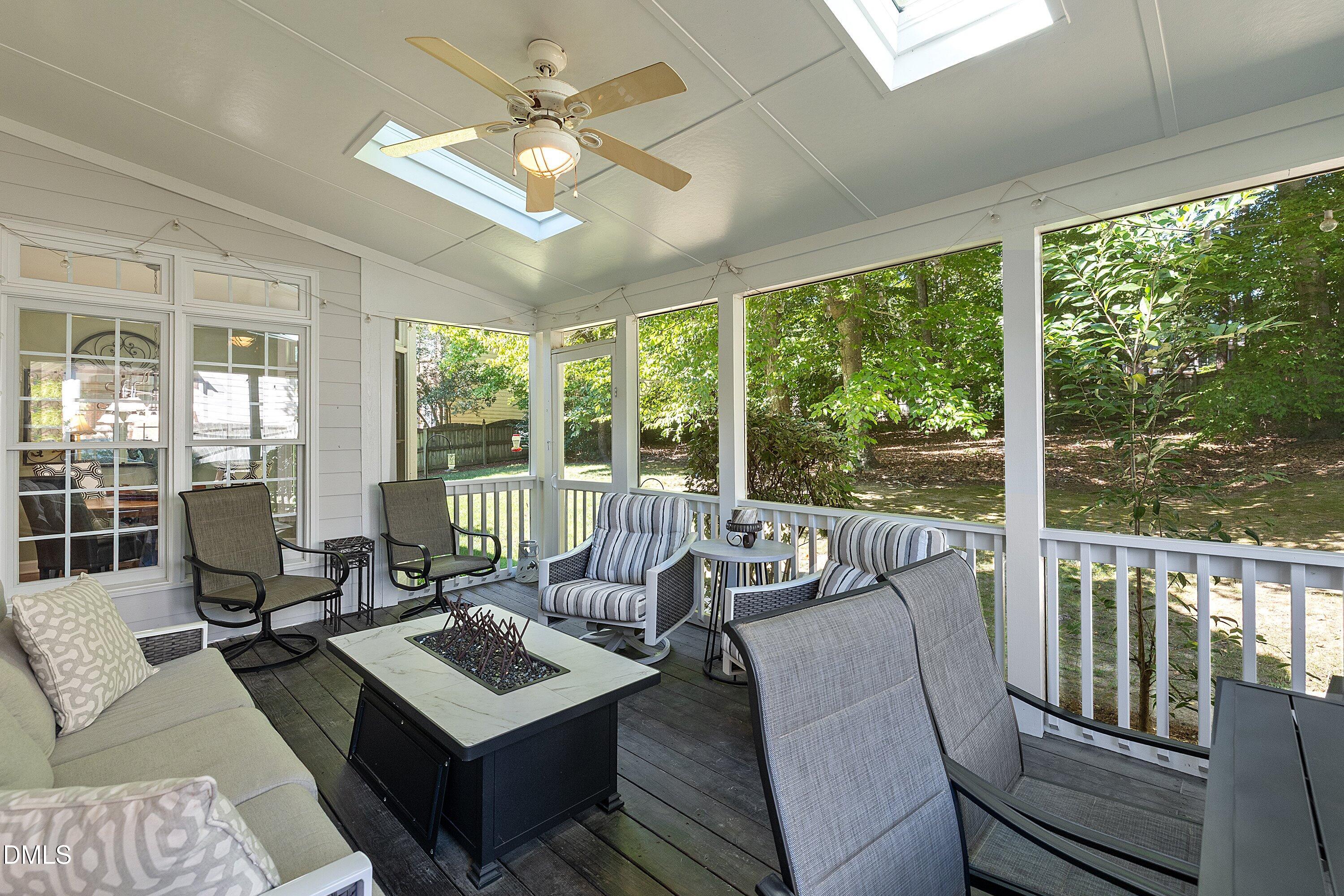 3914 Sterling Ridge Lane Durham, NC 27707 - Photo 30 of 66 Screened porch with a ceiling fan, dual skylights, and wood-finish flooring
