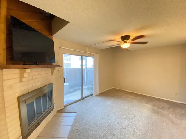 a view of an empty room with a fireplace