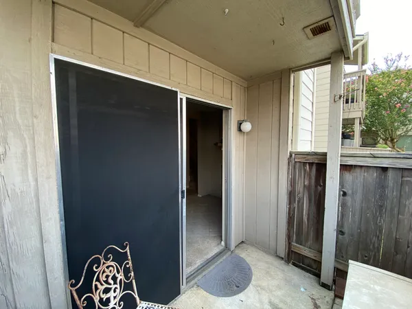 an empty room with a ceiling fan and a window