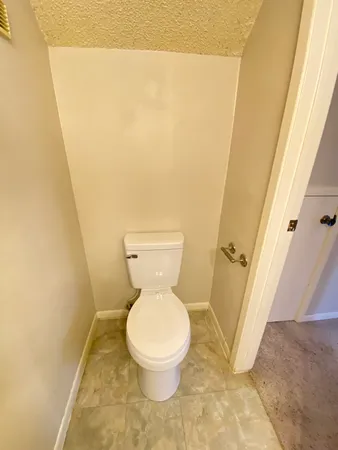 an empty room with windows and a ceiling fan