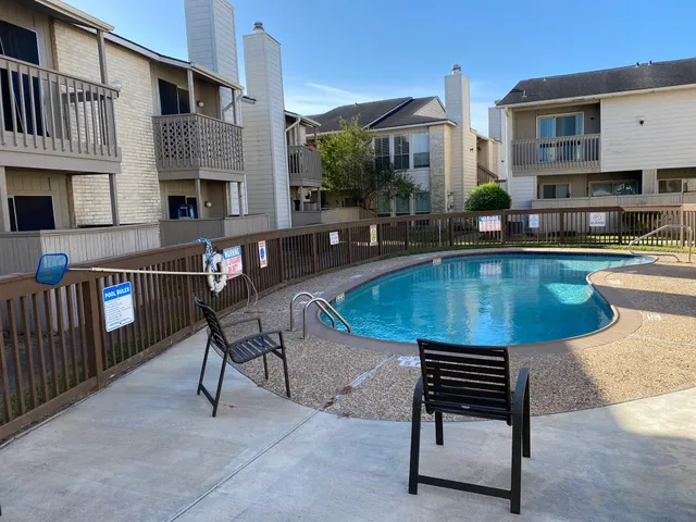 a view of a swimming pool with outdoor seating