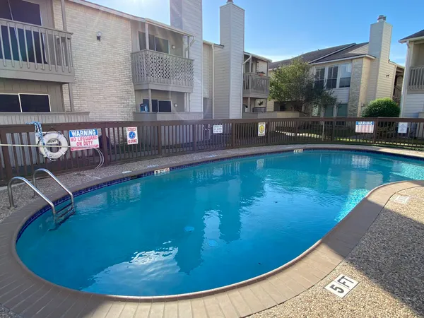 a balcony with table and chairs
