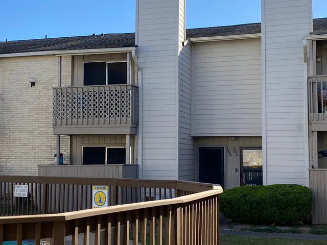 a balcony with table and chairs