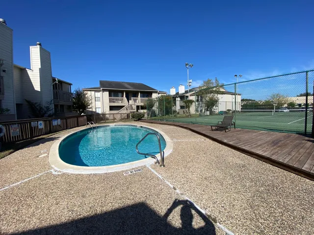a view of a street with potted plants