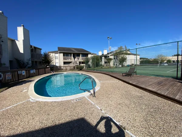 a view of a street with potted plants