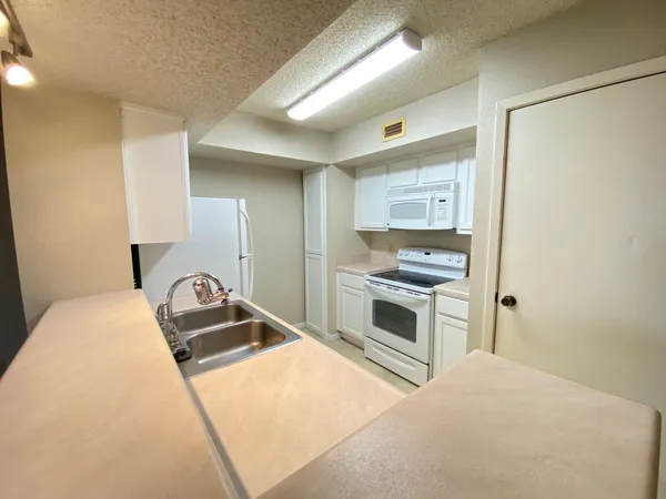 a kitchen with a refrigerator stove and sink