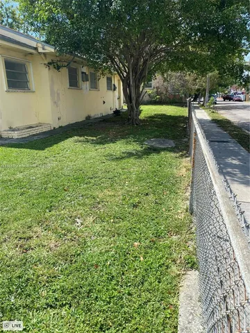 a view of a backyard with large trees