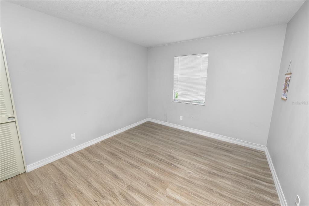 3307 Fox Ridge Drive Winter Haven, FL 33884 - Photo 16 of 27 an empty room with wooden floor and windows