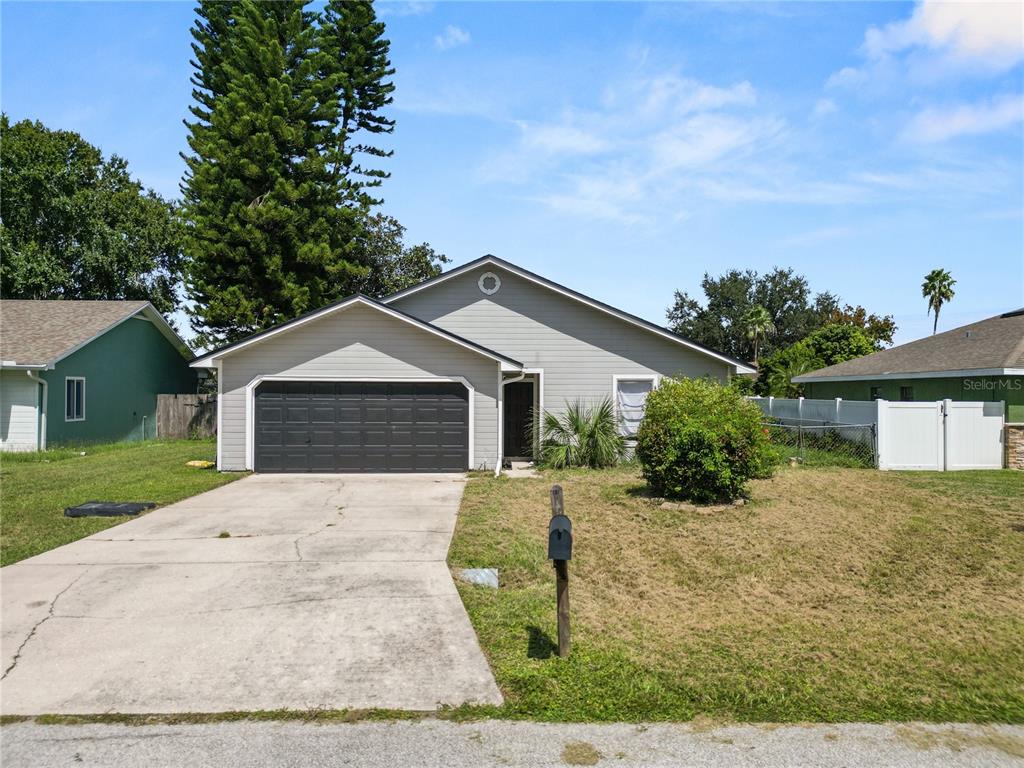 3307 Fox Ridge Drive Winter Haven, FL 33884 - Photo 26 of 27 a front view of a house with a yard and garage