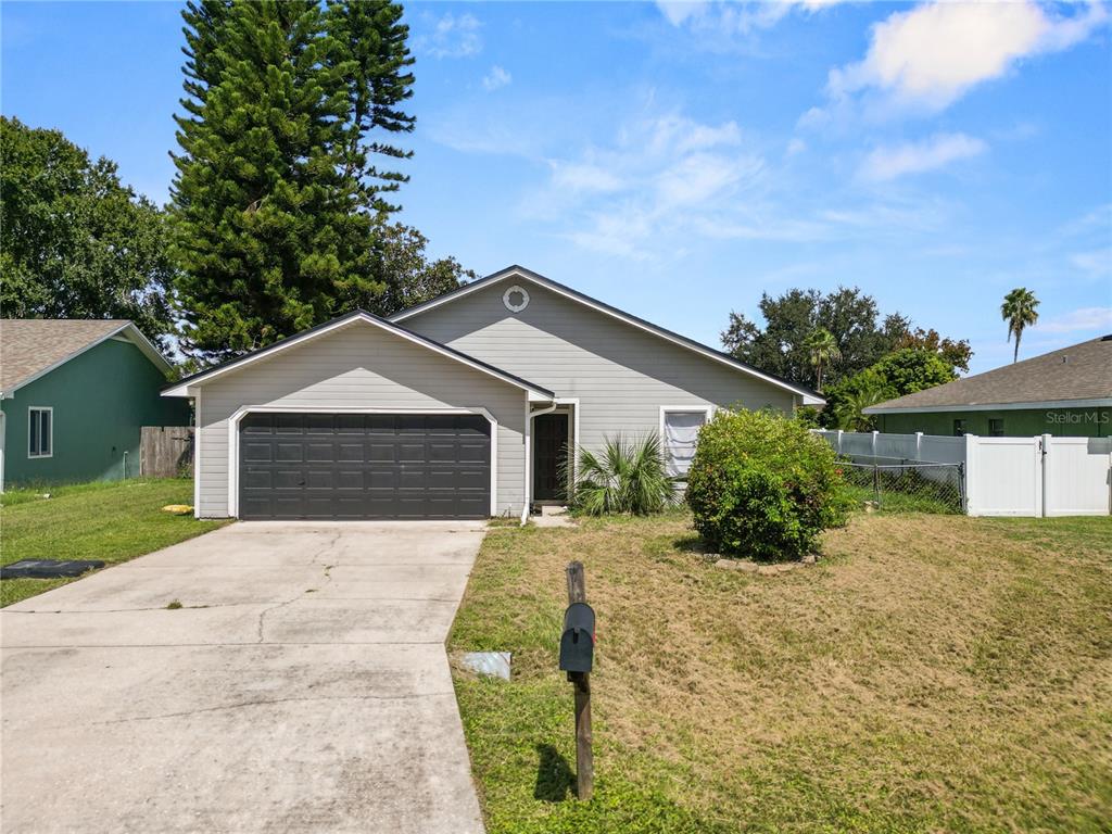 3307 Fox Ridge Drive Winter Haven, FL 33884 - Photo 27 of 27 a front view of house with yard and trees in the background