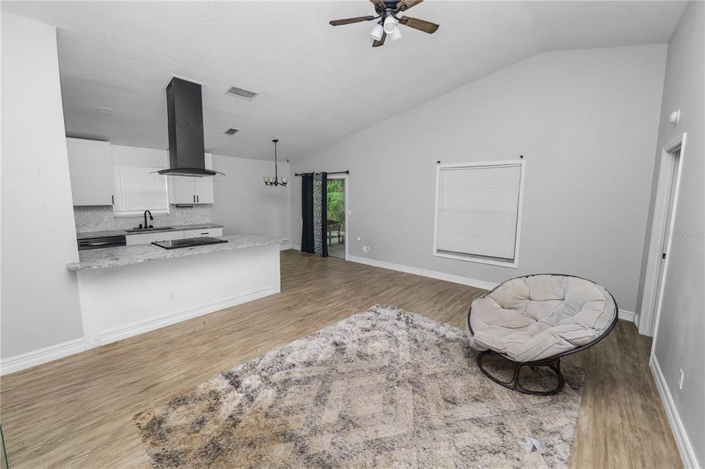 3307 Fox Ridge Drive Winter Haven, FL 33884 - Photo 4 of 27 a view of a kitchen with a sink and a fireplace