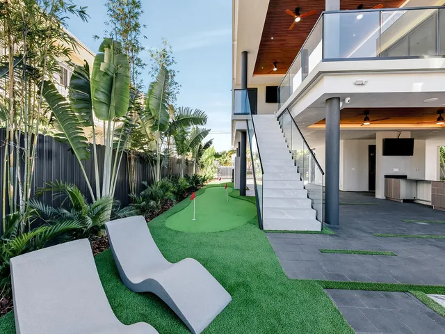 a view of a chair and table in backyard of the house
