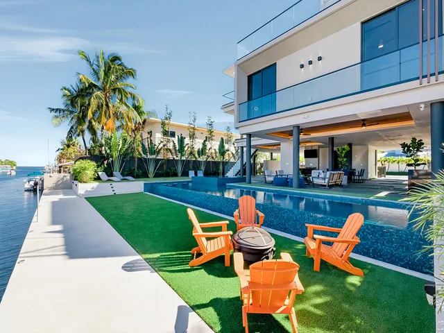 a view of a backyard with plants and outdoor seating