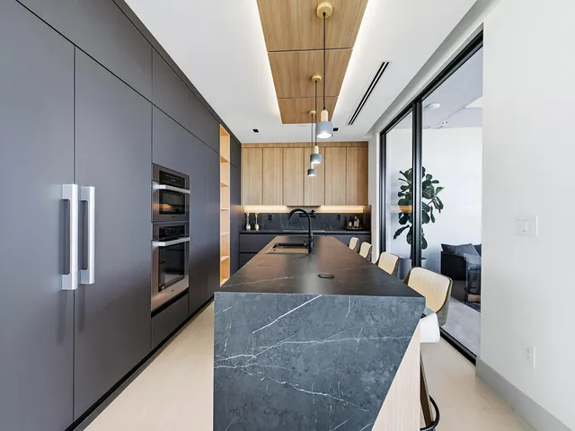 a kitchen with stainless steel appliances granite countertop a sink a counter space and cabinets