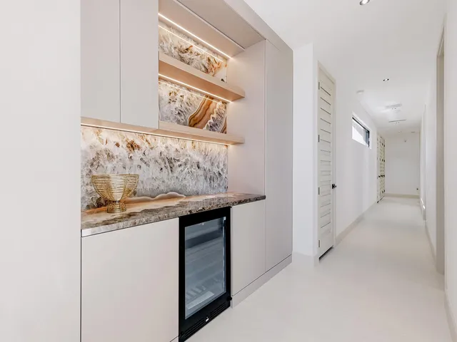 a kitchen with granite countertop white cabinets and a stainless steel appliances