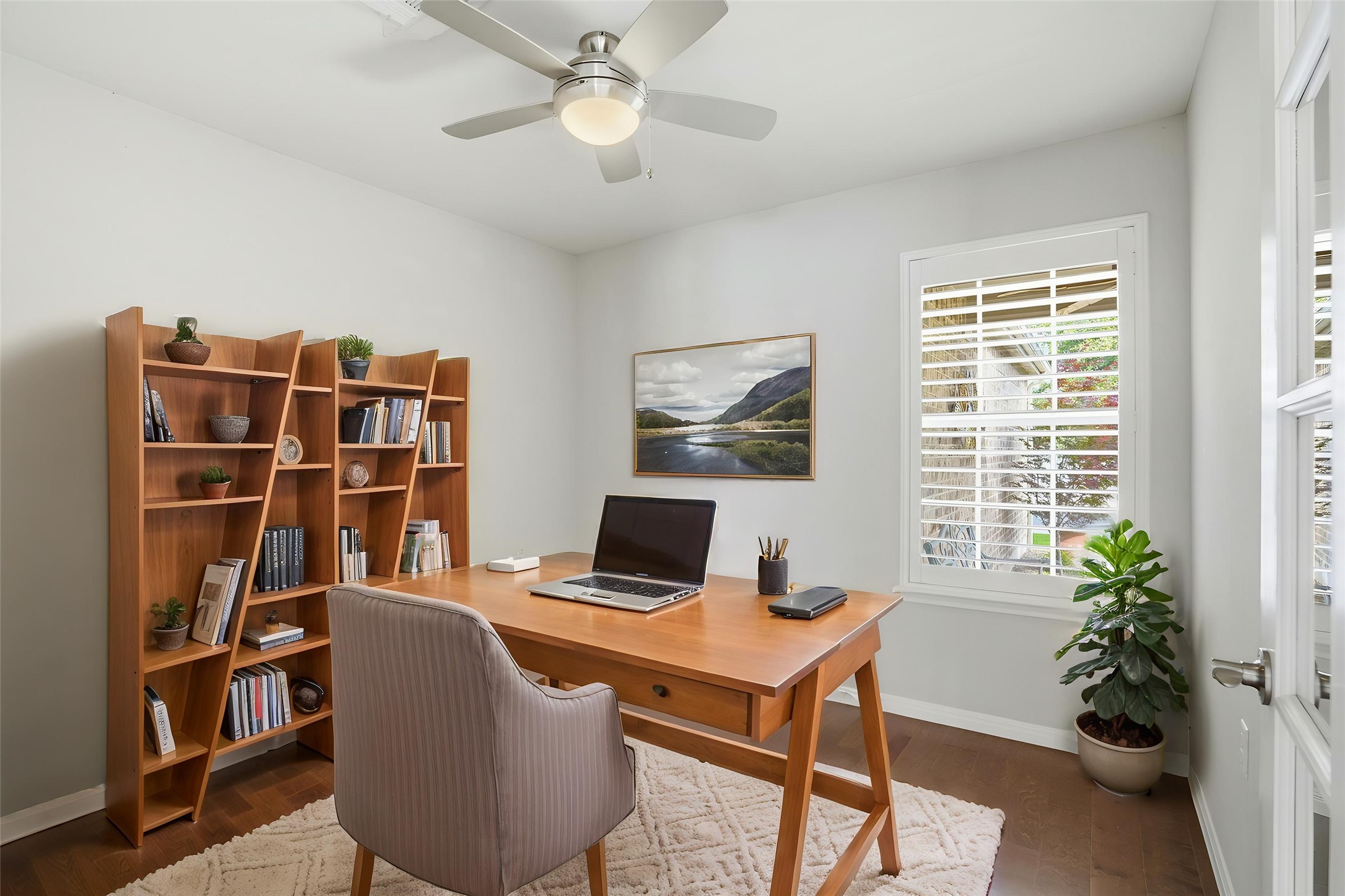 821 Hamilton Lane Georgetown, TX 78633 - Photo 5 of 38 Office space or could be a third bedroom featuring wood floors, a ceiling fan with integrated lighting, and plantation shutters (virtually staged)