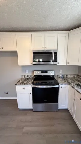 a kitchen with a stove and a microwave